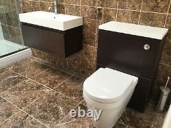 Bathroom sink with wall hung vanity unit and back to wall toilet with unit