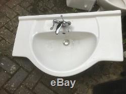 Bathroom white china toilet and vanity sink in good condition