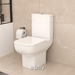 Écran de bain Nes Home avec porte de douche blanche, meuble sous-vasque, toilettes et robinetterie noire mate.